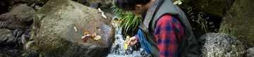 Man collects water sample with handheld instrumentation device. Man collects water sample with handheld instrumentation device.